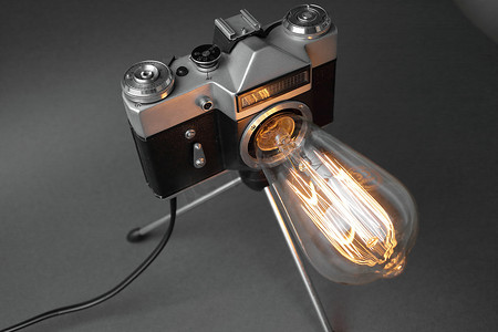 来自旧相机的复古灯，灰色背景上有一盏爱迪生灯。