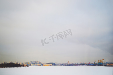 冬季下雪房子摄影照片_从河流看城市的背景冬季景观，文本背景