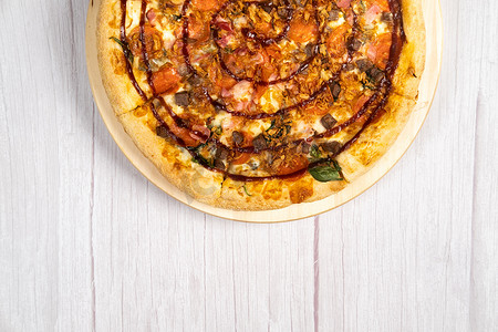 浅色木质背景中配有培根和菠菜的美味大披萨