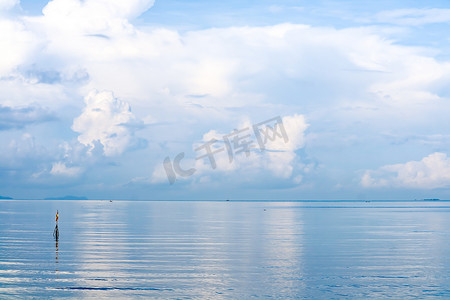 海面蓝色背景摄影照片_夏日清澈蓝天背景下的白云海面