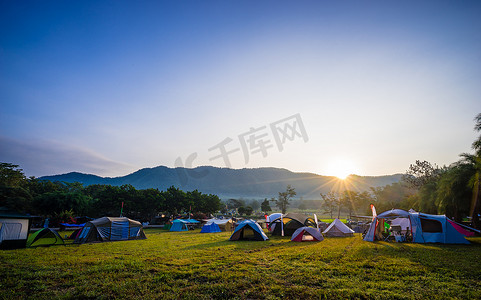 蓝色湖水摄影照片_在山后日出的自然公园露营和帐篷