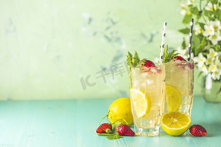 清凉饮料摄影照片_两杯加柠檬和草莓的冰冷清凉饮料