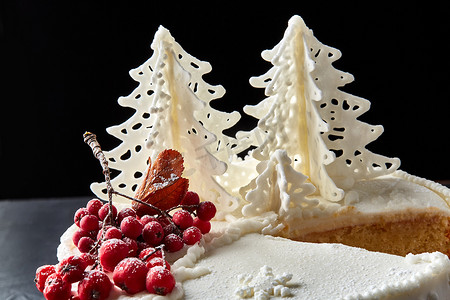冬天的蛋糕上覆盖着白色的糖霜，森林里有彩绘的房子，树木和红罗文。