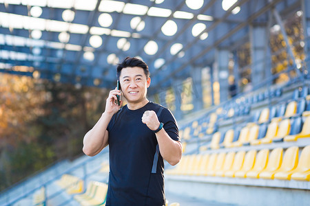 成功的亚洲男运动员通过电话交谈，分享他的运动成就
