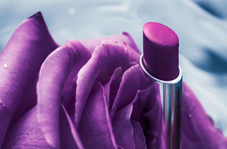 液体背景上的紫色唇膏和玫瑰花、防水魅力化妆品和唇彩化妆品产品，用于豪华美容品牌假日设计