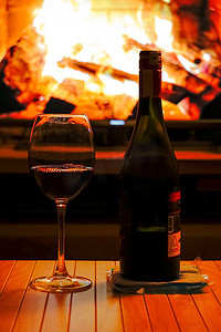 红酒墙摄影照片_在家喝着红酒和智能电视上的壁炉放松一下