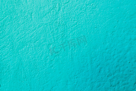墙上凹凸不平的蓝色石膏表面。