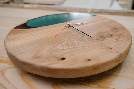 木制圆形挂钟。圆形生态钟由木材和环氧树脂制成。