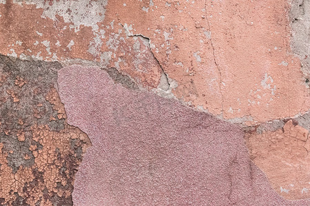 旧的墙面摄影照片_旧彩色墙面纹理粗糙背景的破碎剥落石膏