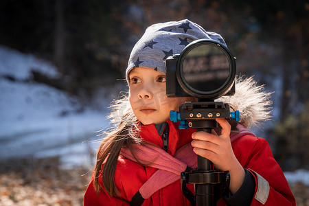 相机录像摄影照片_小女孩学习在大自然中用相机拍照