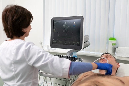 女医生在心脏病诊所使用现代设备对病人进行心脏检查。