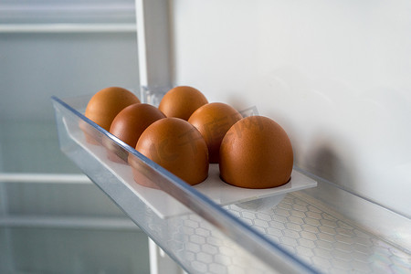 空冰箱里放着 6 个棕色鸡蛋。