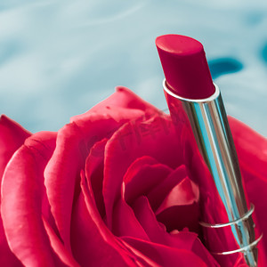 液体背景上的红色唇膏和玫瑰花、防水魅力化妆品和唇彩化妆品产品，用于奢华美容品牌假日设计