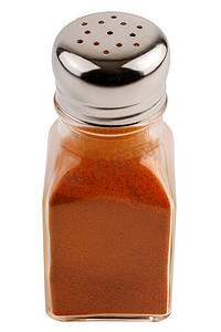 透明罐摄影照片_白色背景中突显的红辣椒粉玻璃胡椒罐