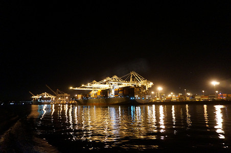 夜间经济摄影照片_满载的运输货船在夜间卸货