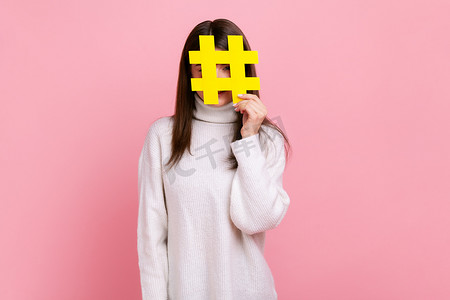 人气标签摄影照片_女性用社交媒体标签符号遮住脸，建议关注流行内容、博客。