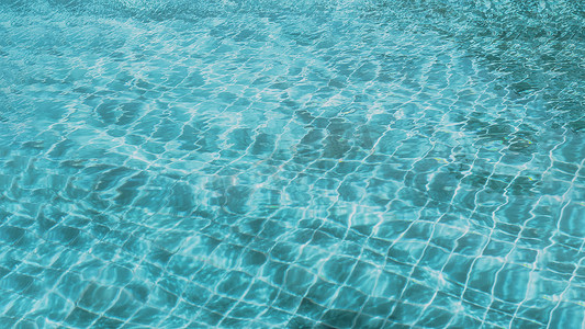 蓝绿色摄影照片_抽象背景图案撕裂水表面游泳池光反射充满活力的蓝绿色