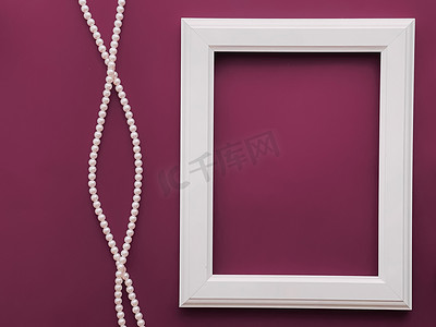 平面设计装饰摄影照片_白色垂直艺术框架和紫色背景珍珠首饰，作为平面设计、艺术品印刷品或相册