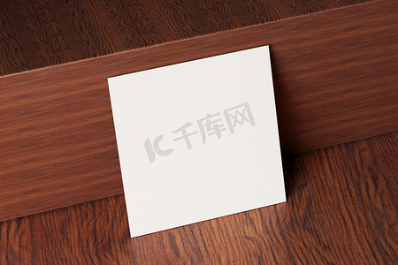孔子名片摄影照片_木制棕色桌子背景上的白色方形纸制名片样机。
