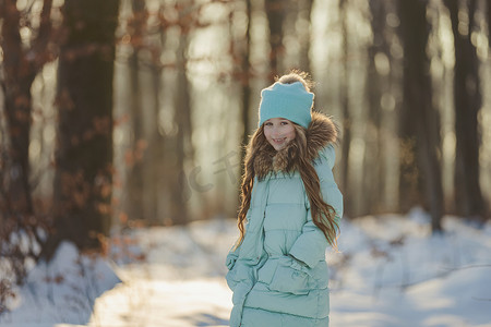 开心色摄影照片_冬天森林里的女孩和绿松石色的衣服