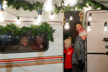 儿童拖车摄影照片_快乐的大家庭在大自然中庆祝圣诞节。