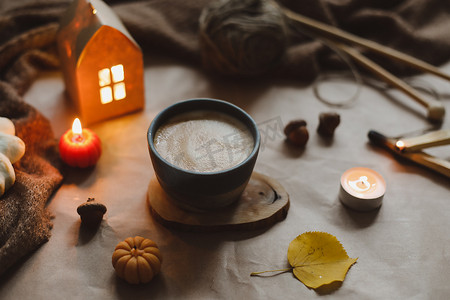秋天的静物画有杯子、蜡烛、格子。 