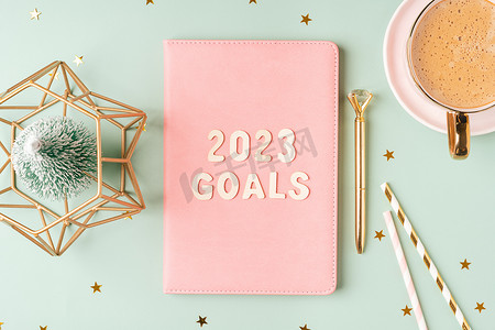 圣诞粉色记事本，上面写着 2023 年目标字母文本。