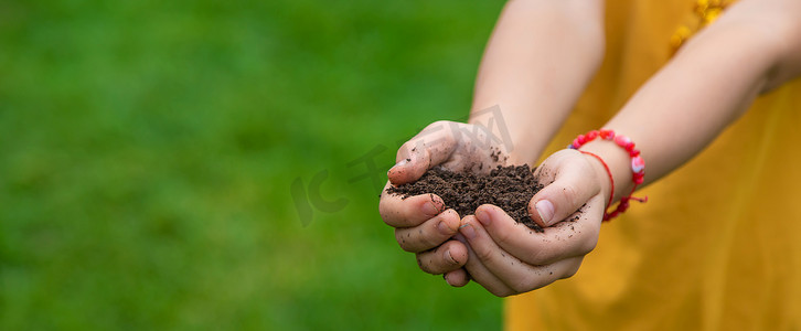 孩子手里拿着泥土。