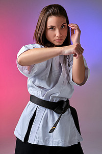 穿着传统和服的运动女性正在工作室练习空手道。