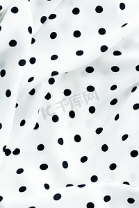 经典的圆点纺织背景纹理，白色奢华面料设计图案上的黑点