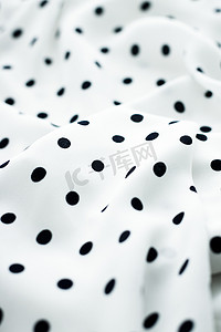 经典的圆点纺织背景纹理，白色奢华面料设计图案上的黑点