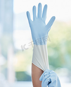女性工人摄影照片_一名面目全非的家政工人在工作时戴着橡胶手套。