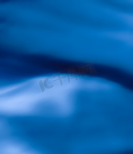 经典质感摄影照片_蓝色抽象艺术背景、丝绸质感和运动波浪线，适合经典奢华设计