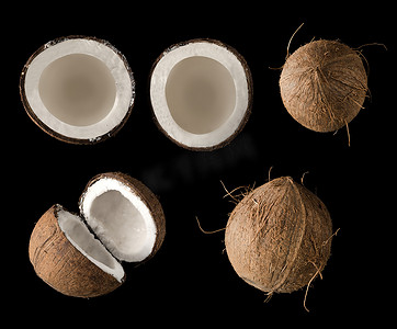 椰子分成两个相等的部分，从顶部看，在孤立的黑色背景上，拼贴