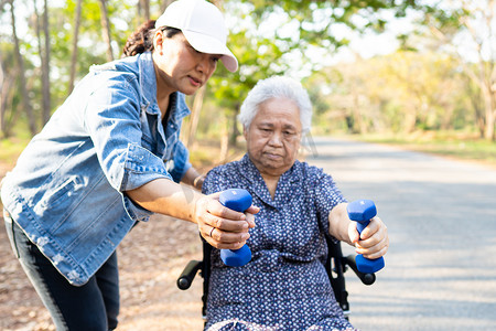 亚洲高级或年长的老太太在公园里用哑铃锻炼。