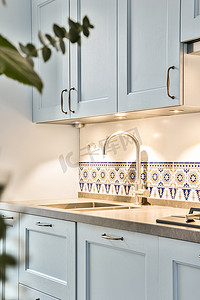 白色的现代厨房摄影照片_带蓝色家具的现代厨房内部