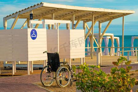 更衣室轮椅海边度假残疾人快乐旅行家庭生活方式，从假期残疾到水从日出健康，帮助白色。
