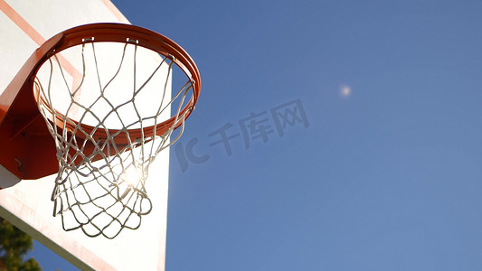 户外篮球场、橙色篮筐、网和篮球比赛的篮板。