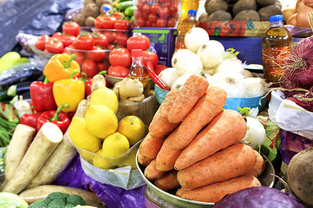 胡萝卜、西红柿、洋葱、辣椒等蔬菜、根类蔬菜以及柠檬、葵花籽油在市场货架上出售。