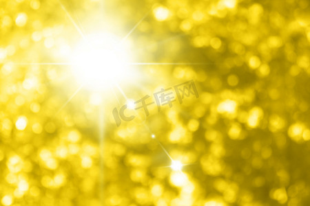 魔术图片摄影照片_美丽闪闪发光的黄金背景，图片上带有照明金黄色散景效果，黄金闪光背景
