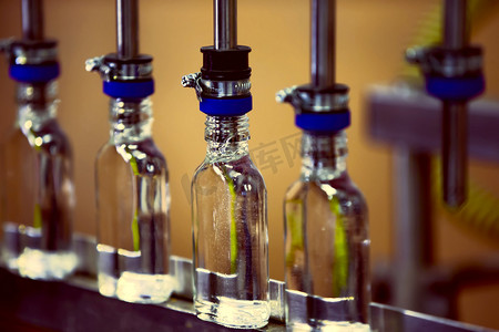 传送带上的一排玻璃瓶用于生产酒精饮料。