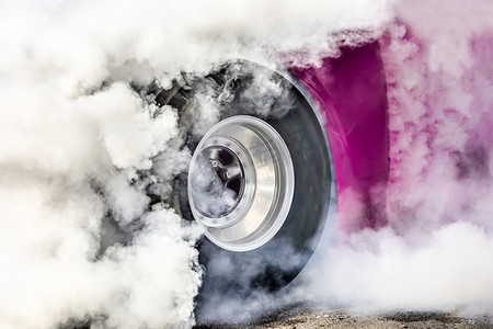 飙车比赛摄影照片_飙车赛车燃烧掉轮胎上的橡胶，为比赛做准备