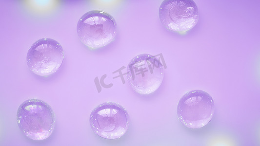 霓虹紫色背景上的抽象玻璃滴珠