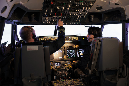 仪表板摄影照片_机长和副驾驶使用仪表板命令驾驶飞机起飞