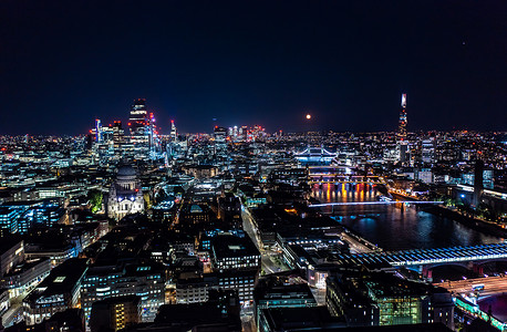 灯光下的城市夜景摄影照片_伦敦城市的美丽夜景，黑色天空下建筑物和街道的灯光