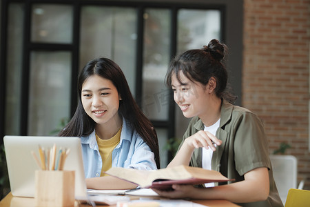 年轻的亚洲学生校园帮助朋友赶上和学习。