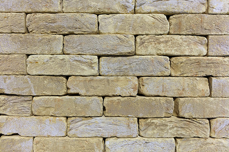 老砖石墙的纹理，米色金色砂岩的建筑石材。