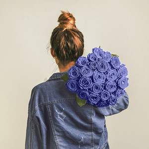 拿着经典蓝玫瑰的女人的背影