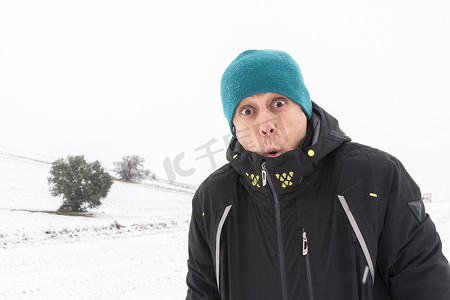 冬天冷的人摄影照片_降雪中非常冷的人。