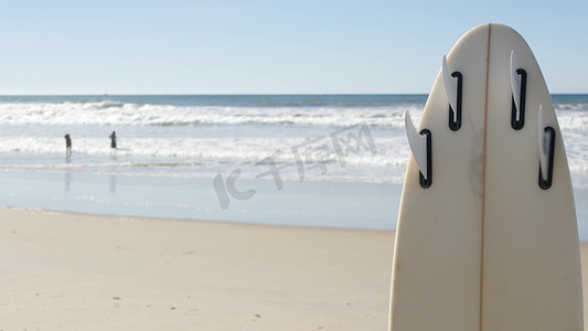 站在美国加利福尼亚海岸沙滩上冲浪的冲浪板。